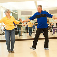 Two people participate in dance class,