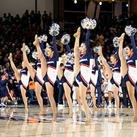 Dance team performs at a basketball game.