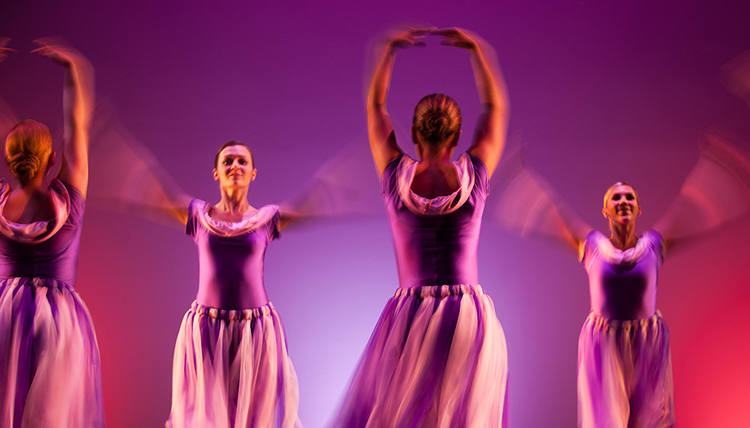 Ballet dancers with purple and pink background