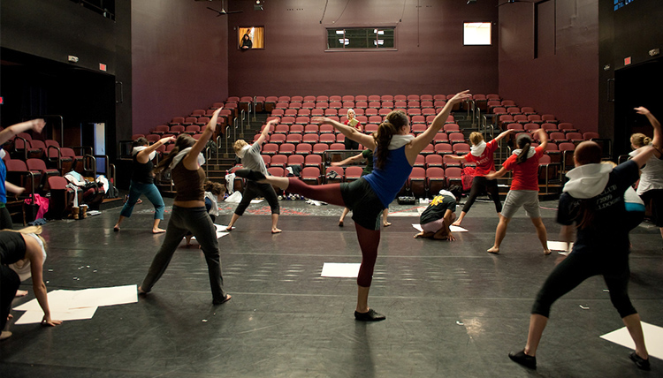 Girls on stage practicing dance
