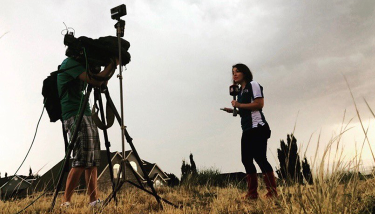 alana brophy in a field with a tv camera