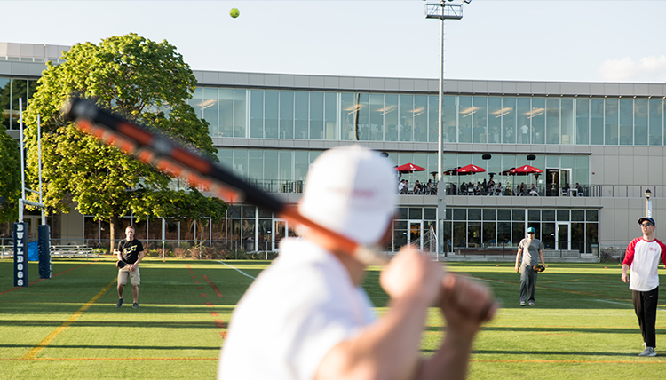 GU student gets ready to hit a softball during his intramural game