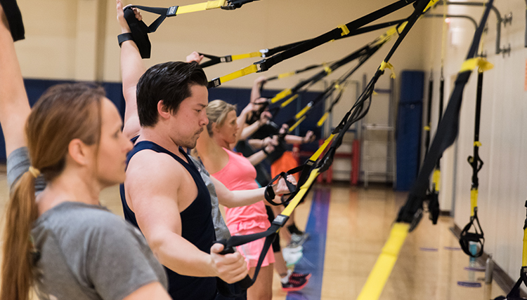 GU student workouts during a TRX fitness class