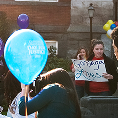 Students hold signs and balloons for Gonzaga University Day of Justice