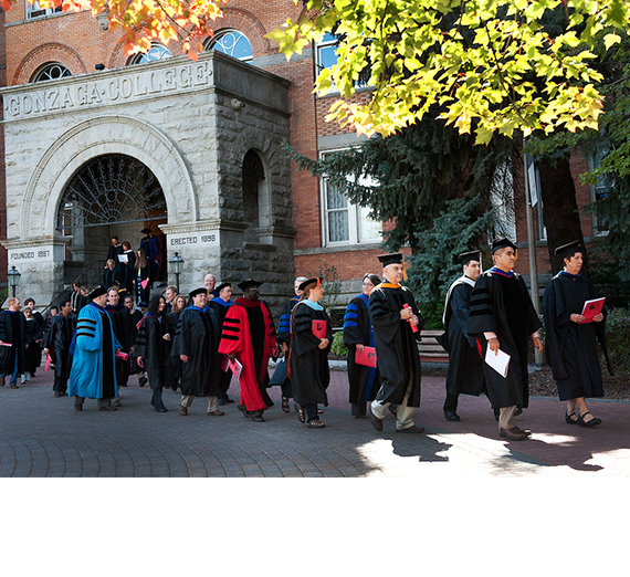 Faculty in academic regalia leaving College Hall in procession