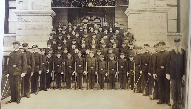 Gonzaga's ROTC members from 1899 gather in front of the steps of College Hall