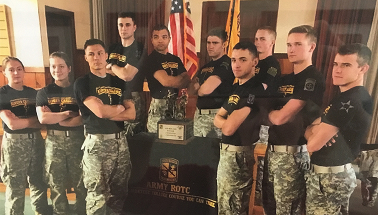 ROTC members of the ranger challenge from 2016 gather around their award