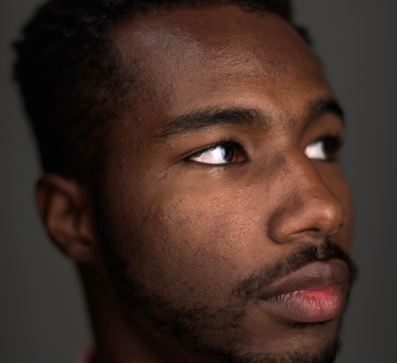 Profile of a smiling young Hispanic man