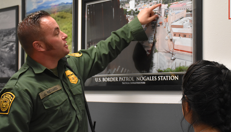 A Border Patrol Agent at the Nogales AZ port of entry visits with Gonzaga students