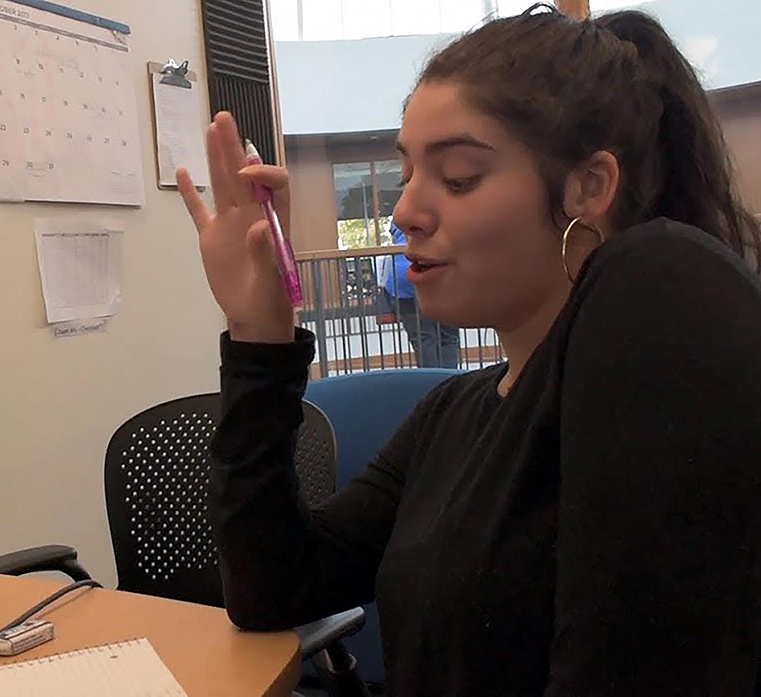 A teacher helping young students