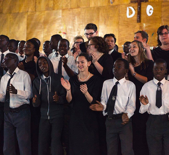 Gonzaga University choir members singing with youth in Zambia, Africa 
