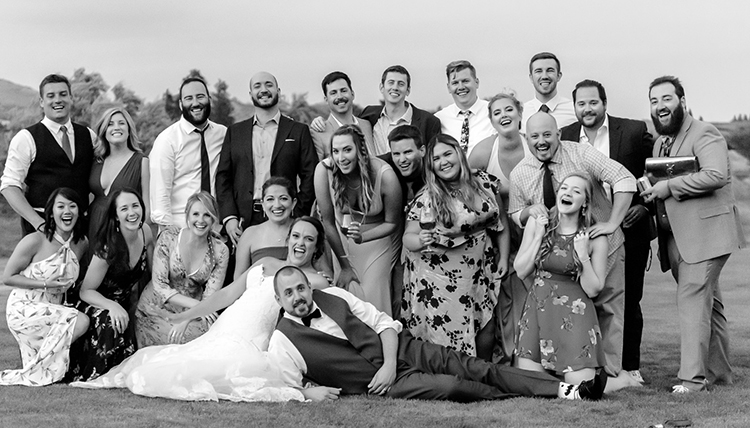 black and white image of couple surrounded by friends