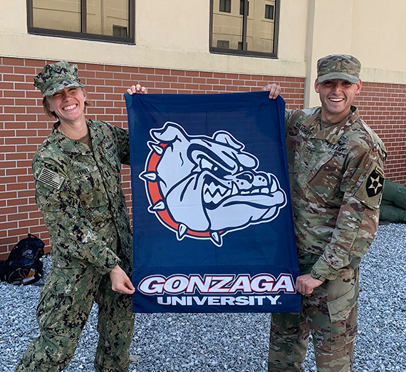 Man in uniform on left and woman posing for headshot on the right.