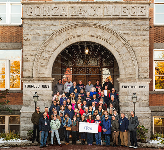 Cat Truong (’14) in front of the mural she created in Gonzaga's advancement office. (Photo by Zack Berlat)