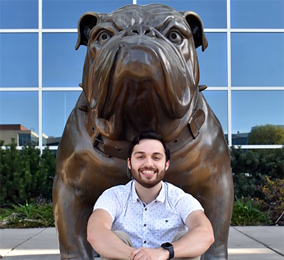 Michael Martin in front of the Bulldog Statue. 