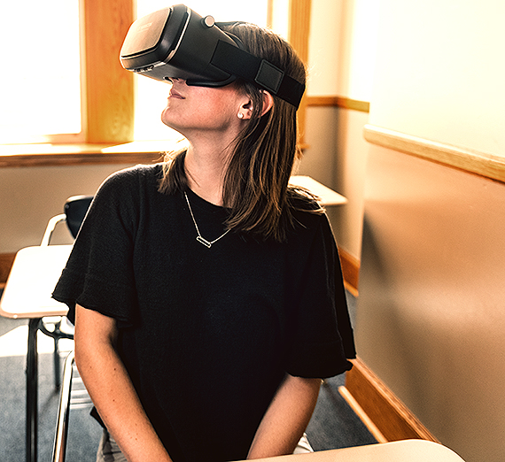 History students viewing an ancient site using a VR rendering.