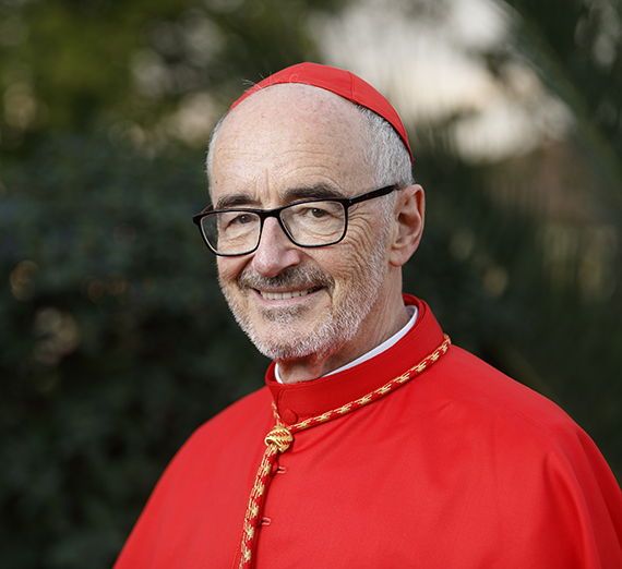 Cardinal Michael Czerny standing at a podium. 