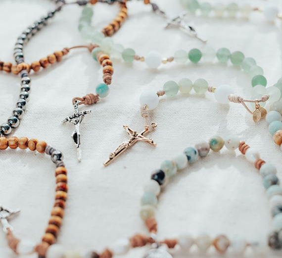 a variety of stone and wooden beads on rosaries 