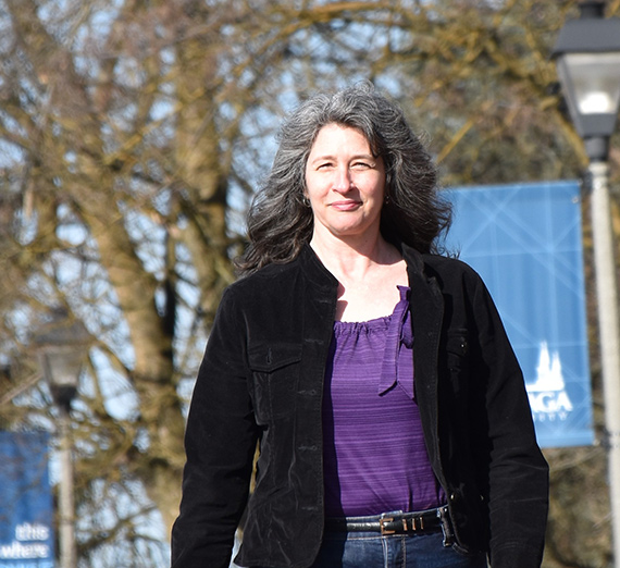 Graduating students hug each other at Commencement.
