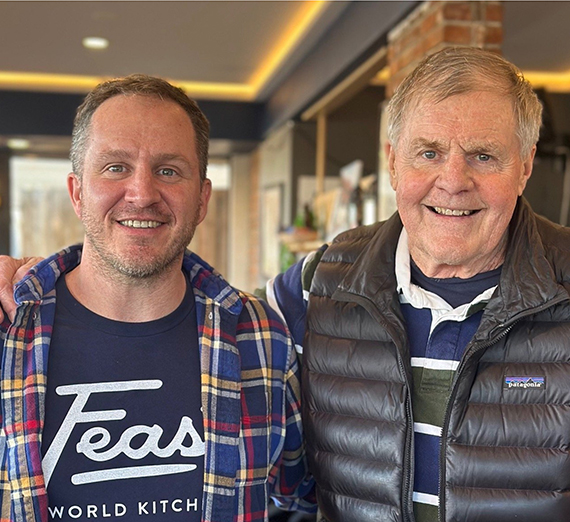 Four people holding trash bags.