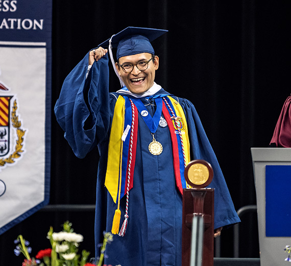 Graduating students hug each other at Commencement.