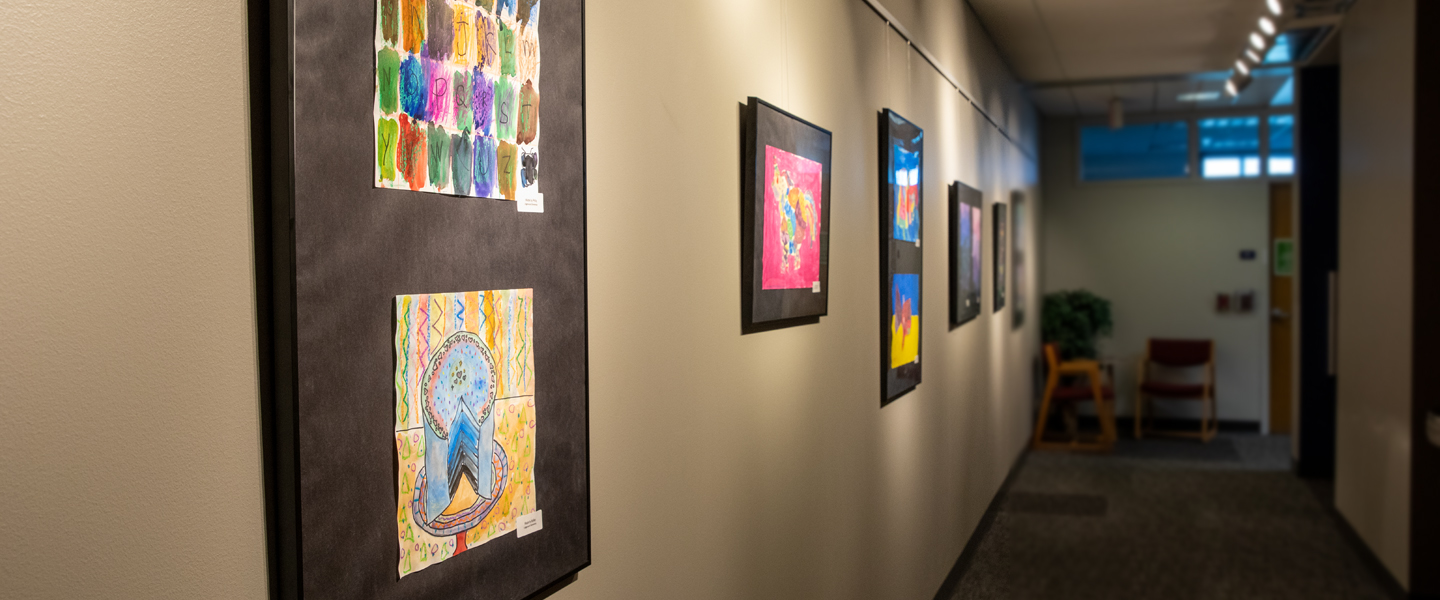 Artwork from local schools hangs in a hallway of the Rosauer Center for Education