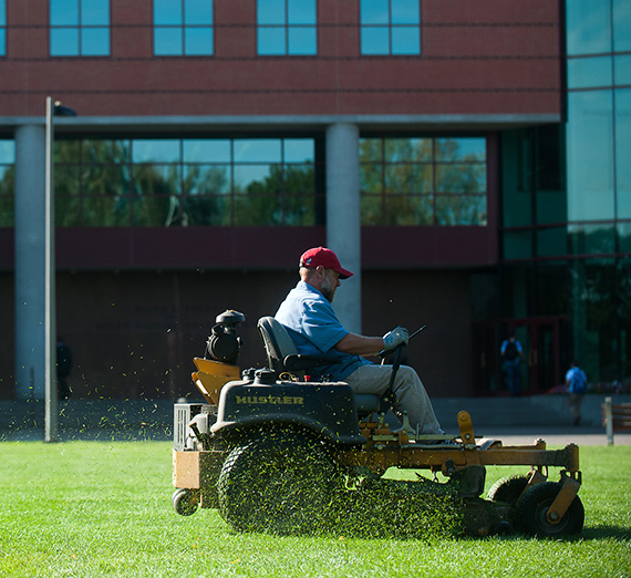 A member of Plant Services mows the Foley Quad on a riding mower A member of Plant Services mows the Foley Quad on a riding mower
