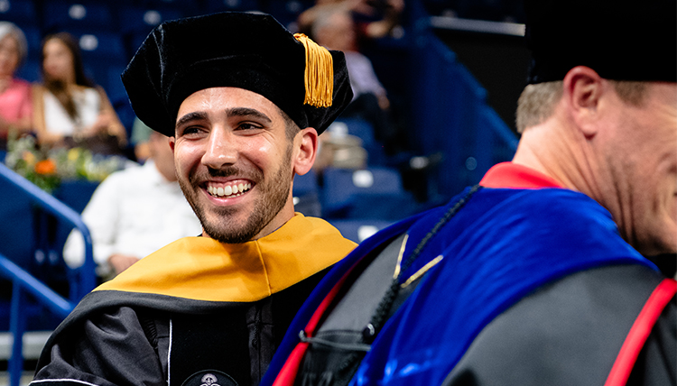 body-grad-commencement-26 A smiling graduate student at Commencement.