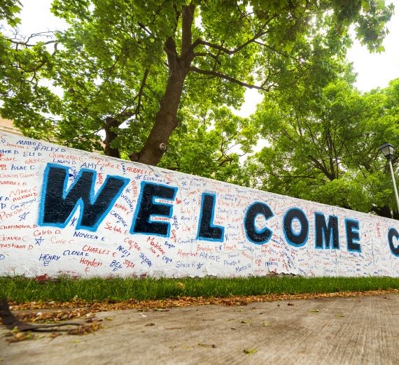 Portion of a wall here on campus with the spray painted word 