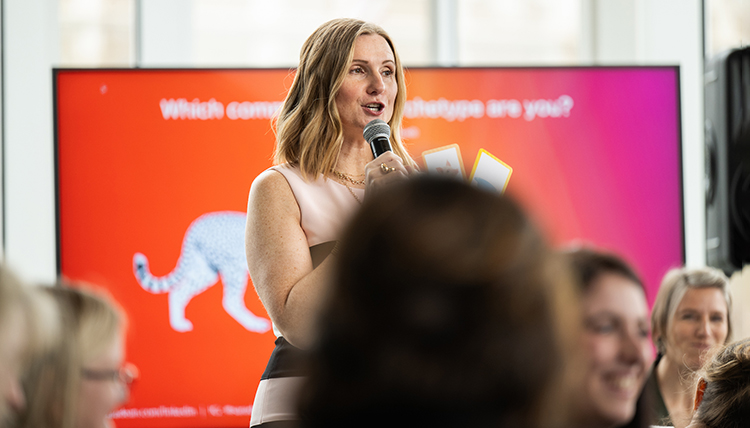 A Woman stands holding a microphone A Woman stands holding a microphone