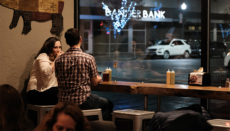 A man and a woman share drinks and a snack at a restaurant in downtown Spokane. A man and a woman share drinks and a snack at a restaurant in downtown Spokane.