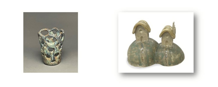 A decorative vase and a sculpture of two hills with houses on top of each.