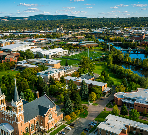 Arial view of the Gonzaga campus surrounded by rivers and mountains.