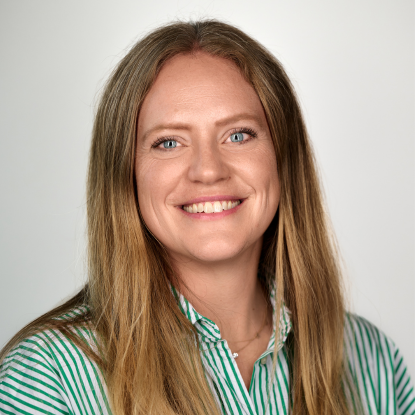 Woman smiles at camera.