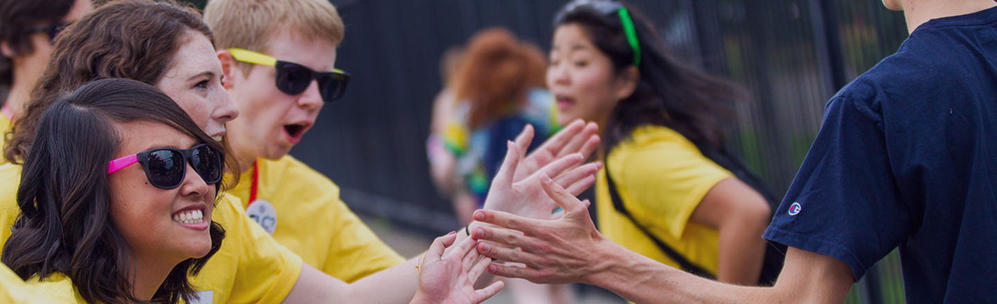 Students high five each other.