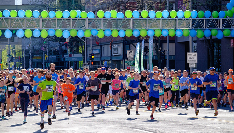 A group of runners take off from the starting line at Bloomsday. A group of runners take off from the starting line at Bloomsday.