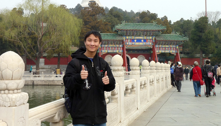 Study Abroad student posing for a picture at a building in China Study Abroad student posing for a picture at a building in China