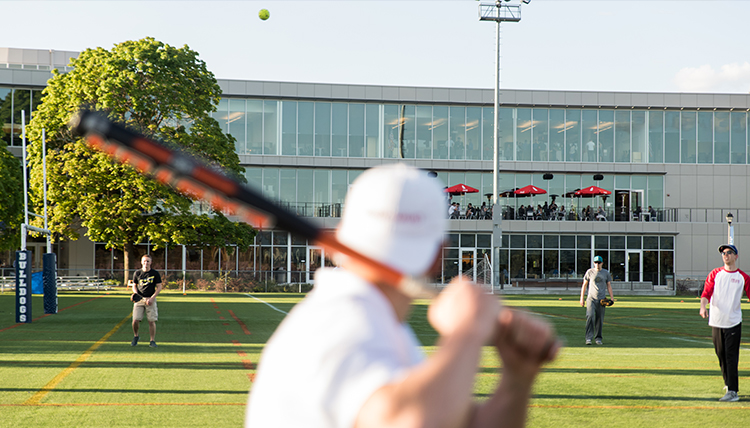 GU student gets ready to hit a softball during his intramural game GU student gets ready to hit a softball during his intramural game