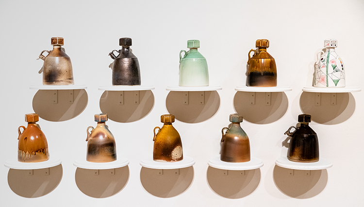 Two rows of five growlers with screw top lids, cast porcelain by Mat Rude from the GU Art Department Faculty Exhibition Two rows of five growlers with screw top lids, cast porcelain by Mat Rude from the GU Art Department Faculty Exhibition