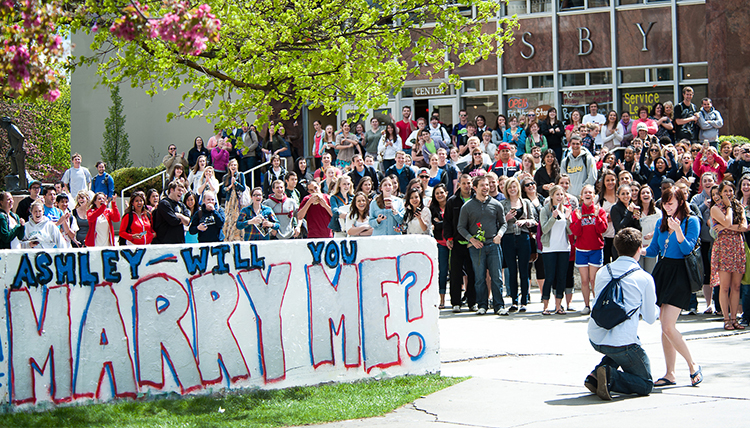 student proposes to girlfriend by the wall student proposes to girlfriend by the wall
