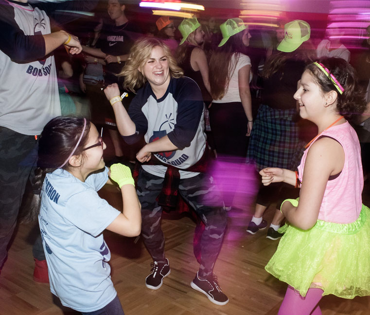 Volunteer and kids dancing at Dance Marathon