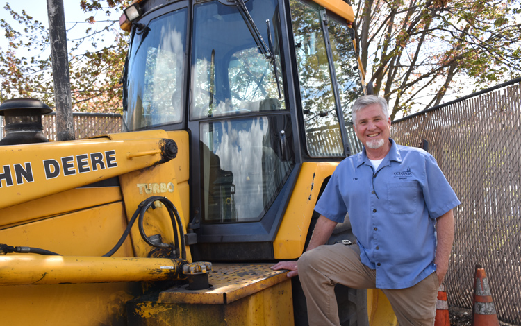 Tye McGee, Groundskeeper Supervisor outside with a tractor. Tye McGee, Groundskeeper Supervisor outside with a tractor.