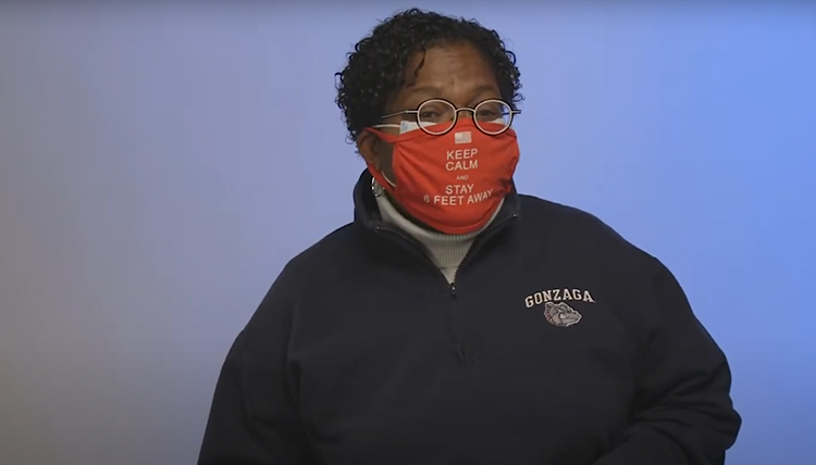 woman wearing GU sweatshirt and a red mask that says Keep Calm and Stay 6 Feet Away woman wearing GU sweatshirt and a red mask that says Keep Calm and Stay 6 Feet Away