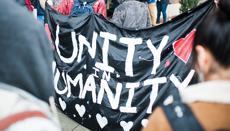 students gather to support people of color, hold sign says diversity in humanity students gather to support people of color, hold sign says diversity in humanity