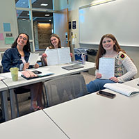 students-school-of-education Three students in a classroom setting