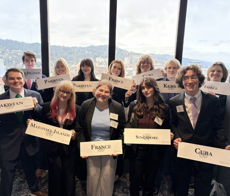The 2026 Gonzaga University Model United Nations holding up signs with country names on them. 