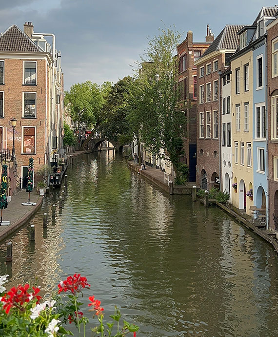 Scenic view of tall vintage European townhouses lining a canal