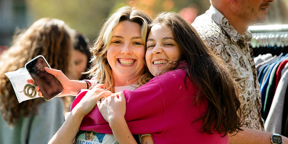 Two students embrace
