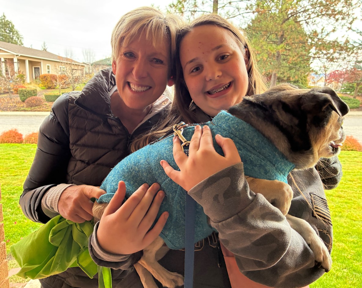 Melissa Taylor and Keylee Frampton holding a dog. Melissa Taylor and Keylee Frampton holding a dog.