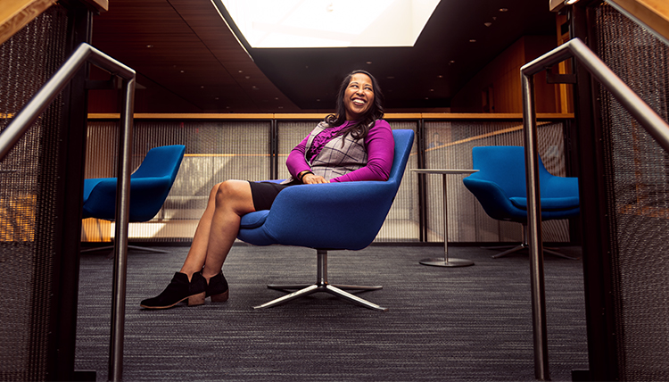 woman sits and smiles woman sits and smiles
